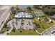 Aerial view of community amenities including pool, tennis courts, playground, and parking at 1798 Flourish Ave, Kissimmee, FL 34744