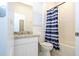 Small bathroom with a shower/tub combo and granite countertop at 1798 Flourish Ave, Kissimmee, FL 34744