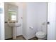Clean and modern half bathroom with pedestal sink and toilet at 1798 Flourish Ave, Kissimmee, FL 34744