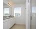 Bathroom with double vanity, large mirror and shower at 1798 Flourish Ave, Kissimmee, FL 34744