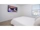 Cozy bedroom with a comfortable bed and wall-mounted TV at 1798 Flourish Ave, Kissimmee, FL 34744