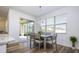 Dining area with sliding glass doors to backyard and wood-look floors at 1798 Flourish Ave, Kissimmee, FL 34744