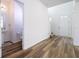 Open entryway with wood-look floors and access to powder room at 1798 Flourish Ave, Kissimmee, FL 34744