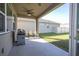 Covered patio with grill and seating, overlooking backyard at 1798 Flourish Ave, Kissimmee, FL 34744