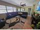 Spacious living room featuring a large sectional sofa and tile flooring at 206 Cooke St, Leesburg, FL 34748
