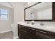 Double vanity bathroom with modern fixtures and a large mirror at 218 Brooke'S Pl, Haines City, FL 33844