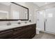 Modern bathroom with dark wood cabinets and a walk-in shower at 218 Brooke'S Pl, Haines City, FL 33844