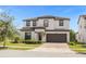 Two-story house with a brown door and garage at 218 Brooke'S Pl, Haines City, FL 33844