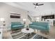 Living room with teal couches and a white coffee table at 218 Brooke'S Pl, Haines City, FL 33844
