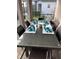 Patio dining set with glass top table and wicker chairs at 218 Brooke'S Pl, Haines City, FL 33844