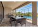 Outdoor patio with table, chairs, and grill overlooking pool at 218 Brooke'S Pl, Haines City, FL 33844