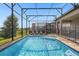 Screened-in pool with lounge chairs and backyard views at 218 Brooke'S Pl, Haines City, FL 33844