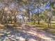 Driveway entrance to the property with mature trees at 23917 Kays Way, Astatula, FL 34705