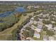 Aerial view of neighborhood near golf course and lake at 24946 Cranes Roost Circle, Leesburg, FL 34748