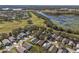 Aerial view of neighborhood near golf course and lake at 24946 Cranes Roost Circle, Leesburg, FL 34748