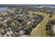 Aerial view of neighborhood near golf course and lake at 24946 Cranes Roost Circle, Leesburg, FL 34748