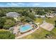 Aerial view showing clubhouse, pool, and landscape at 24946 Cranes Roost Circle, Leesburg, FL 34748