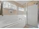 Bathroom with a shower, garden window, and a soaking tub at 24946 Cranes Roost Circle, Leesburg, FL 34748