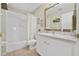 Clean bathroom with a shower/tub combo, white vanity, and tile flooring at 24946 Cranes Roost Circle, Leesburg, FL 34748