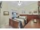Guest bedroom with a wooden bed frame, dresser, and window coverings at 24946 Cranes Roost Circle, Leesburg, FL 34748