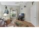 Bonus room with a brown leather couch, TV, and wood flooring at 24946 Cranes Roost Circle, Leesburg, FL 34748
