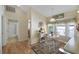 Bright breakfast nook features a round table and chairs, adjacent to a bathroom and hardwood floors at 24946 Cranes Roost Circle, Leesburg, FL 34748