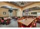 Community room with tables and a bar area at 24946 Cranes Roost Circle, Leesburg, FL 34748