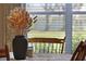 Table setting with vase of dried flowers in dining room at 24946 Cranes Roost Circle, Leesburg, FL 34748