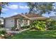 One-story home with brick accents, screened porch, and landscaped yard at 24946 Cranes Roost Circle, Leesburg, FL 34748