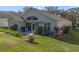 House exterior showcases a patio and well-maintained yard at 24946 Cranes Roost Circle, Leesburg, FL 34748