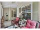 Relaxing front porch with wicker rocking chairs and rug at 24946 Cranes Roost Circle, Leesburg, FL 34748