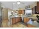 Kitchen boasts stainless steel appliances and light wood cabinets at 24946 Cranes Roost Circle, Leesburg, FL 34748