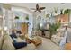 Spacious living room with vaulted ceiling, hardwood floors, and comfy seating at 24946 Cranes Roost Circle, Leesburg, FL 34748