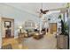 Bright living room with hardwood floors, neutral walls, and comfortable seating at 24946 Cranes Roost Circle, Leesburg, FL 34748