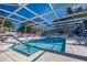 Community pool with screened enclosure and lounge chairs at 24946 Cranes Roost Circle, Leesburg, FL 34748