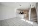 Open living space with kitchen and staircase views at 251 Blueberry Ln, Davenport, FL 33837