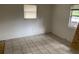 Simple bedroom with tile flooring and two windows at 2732 Westside Dr, Leesburg, FL 34748