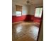 Red-walled bedroom with tile flooring and two windows at 2732 Westside Dr, Leesburg, FL 34748