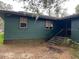 Green house exterior with steps leading to the entrance at 2732 Westside Dr, Leesburg, FL 34748