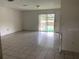Spacious living room with tile flooring and sliding glass doors at 2732 Westside Dr, Leesburg, FL 34748