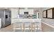 Modern kitchen features stainless steel appliances and an island with seating at 3106 Tobago Dr, Haines City, FL 33844