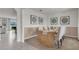 Bright dining room with a farmhouse style table and view into the living room at 3230 Belize Pl, Haines City, FL 33844