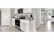 White kitchen cabinets and stainless steel appliances at 3234 Belize Pl, Haines City, FL 33844