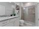 Bathroom with granite countertop and shower at 7424 Oakmoss Loop, Davenport, FL 33837