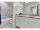 Bathroom with double vanity and granite countertop at 7424 Oakmoss Loop, Davenport, FL 33837
