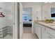 Bathroom with double vanity and access to bedroom at 7424 Oakmoss Loop, Davenport, FL 33837