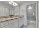 Double vanity bathroom with granite countertop at 7424 Oakmoss Loop, Davenport, FL 33837
