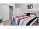 Bedroom with striped bedding and closet at 7424 Oakmoss Loop, Davenport, FL 33837