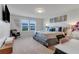 Main bedroom with large bed, TV and window at 7424 Oakmoss Loop, Davenport, FL 33837
