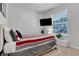 Bedroom with striped bedding and TV at 7424 Oakmoss Loop, Davenport, FL 33837